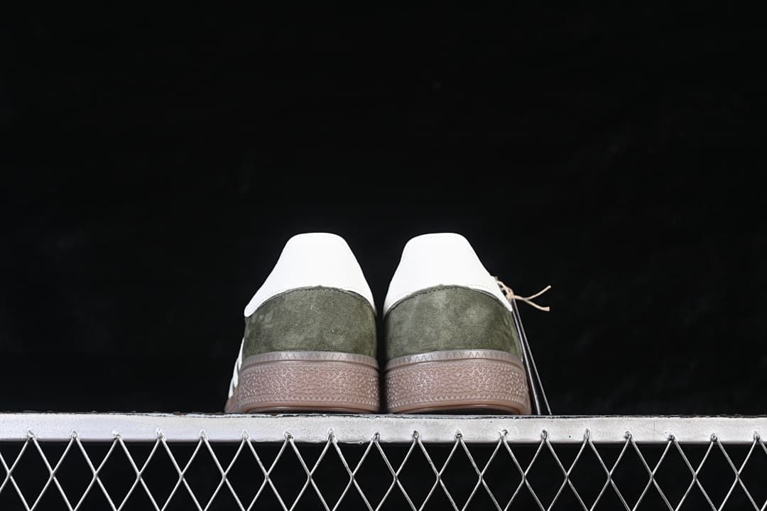 Rear view of both sneakers showing white heel panels and gum-colored soles