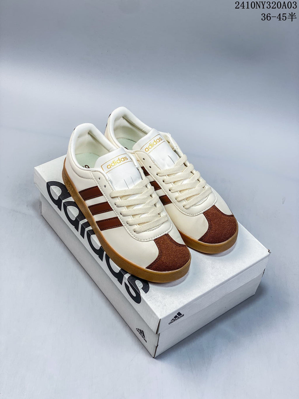 Pair of cream Adidas VL Court 2.0 sneakers with brown stripes and gum-colored soles