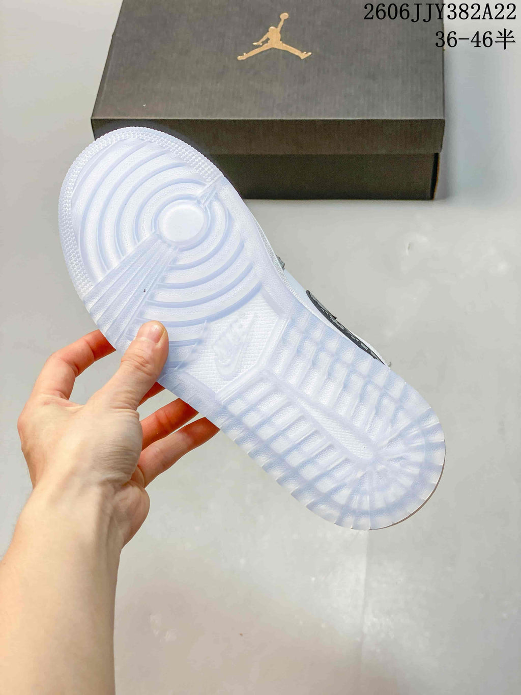 Underside of a sneaker showing a pale translucent-looking outsole