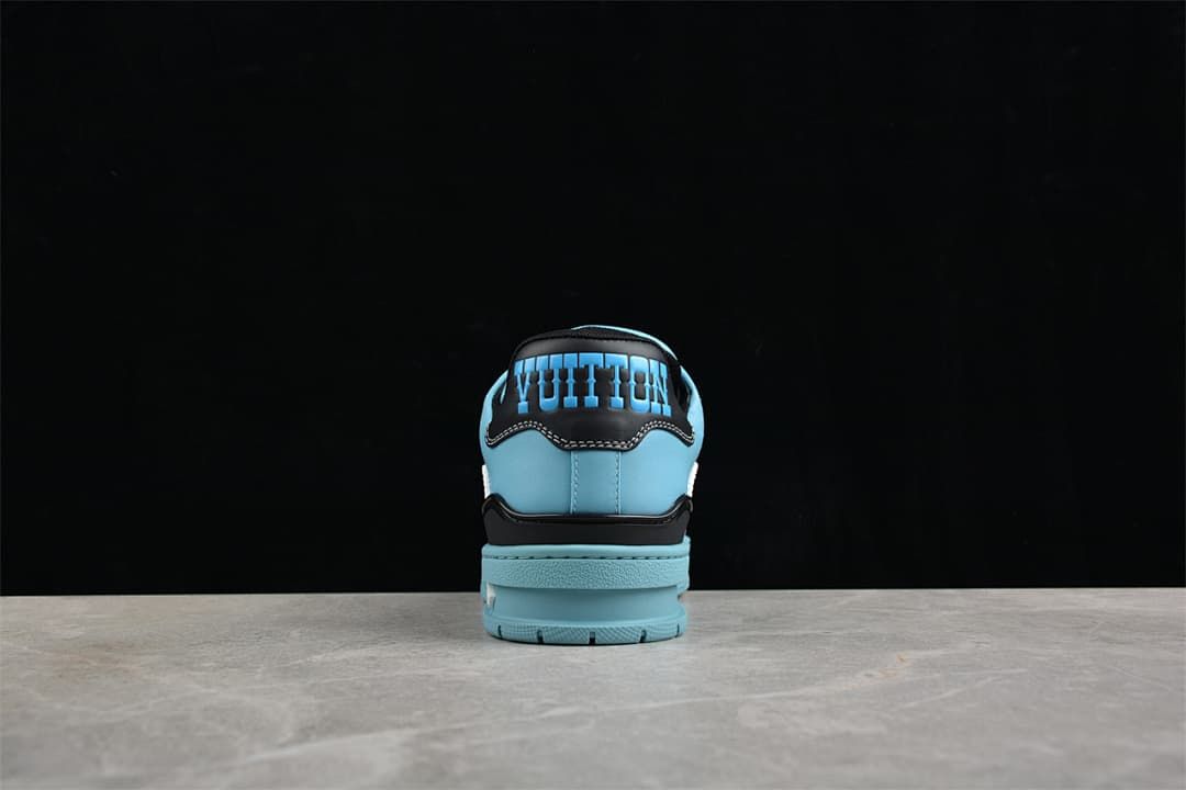 Rear view of a blue sneaker with a navy heel panel and raised lettering