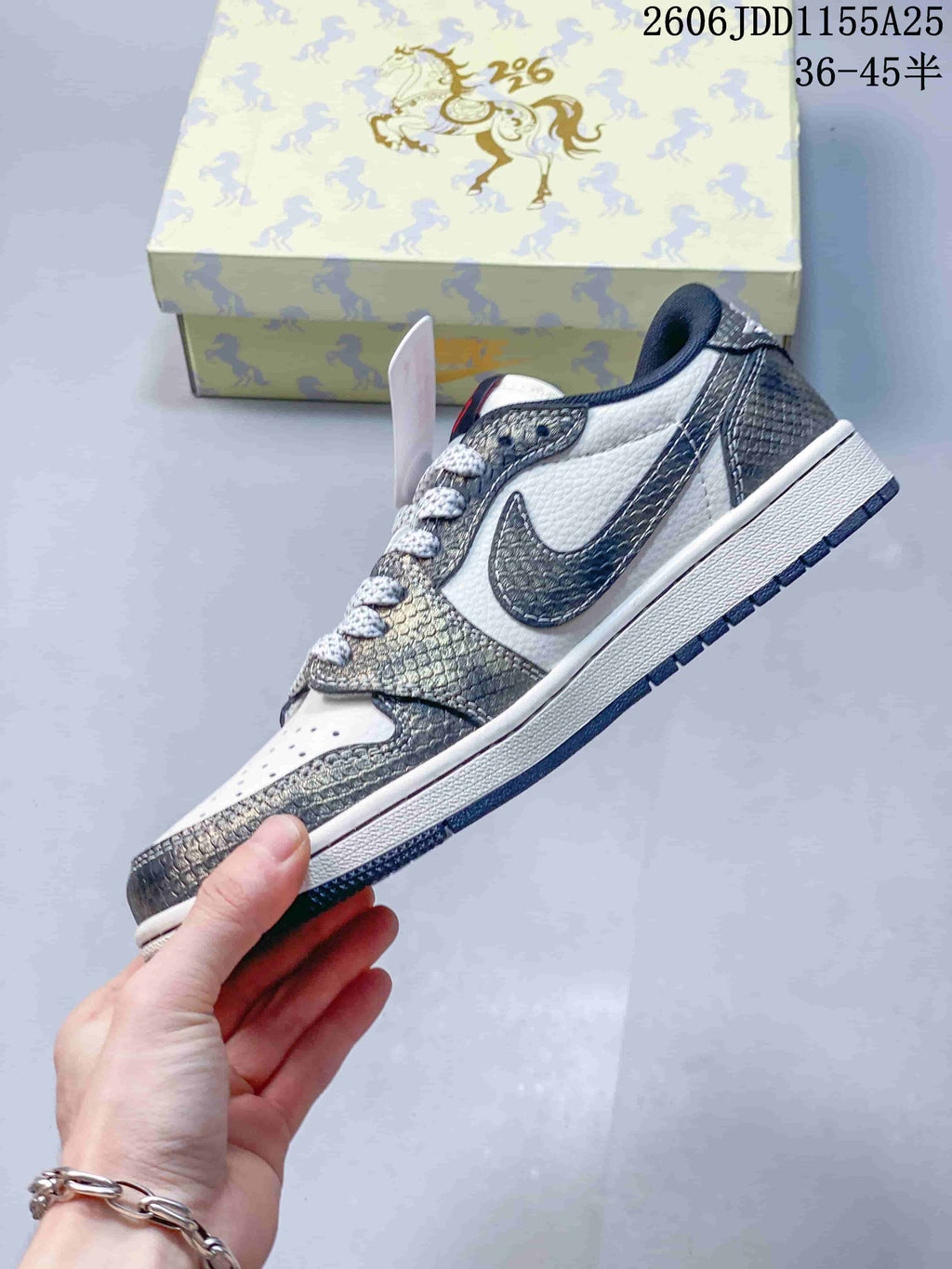 Side profile of a white and metallic gray low-top sneaker