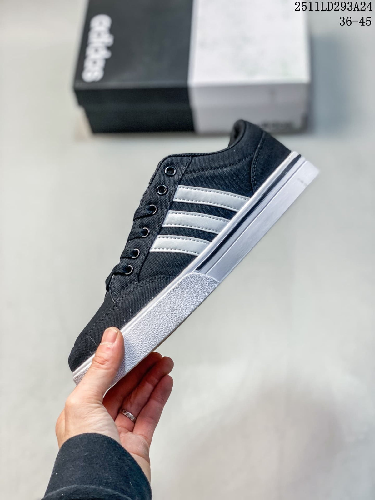Side view of the navy sneaker with white stripes and a white sole.