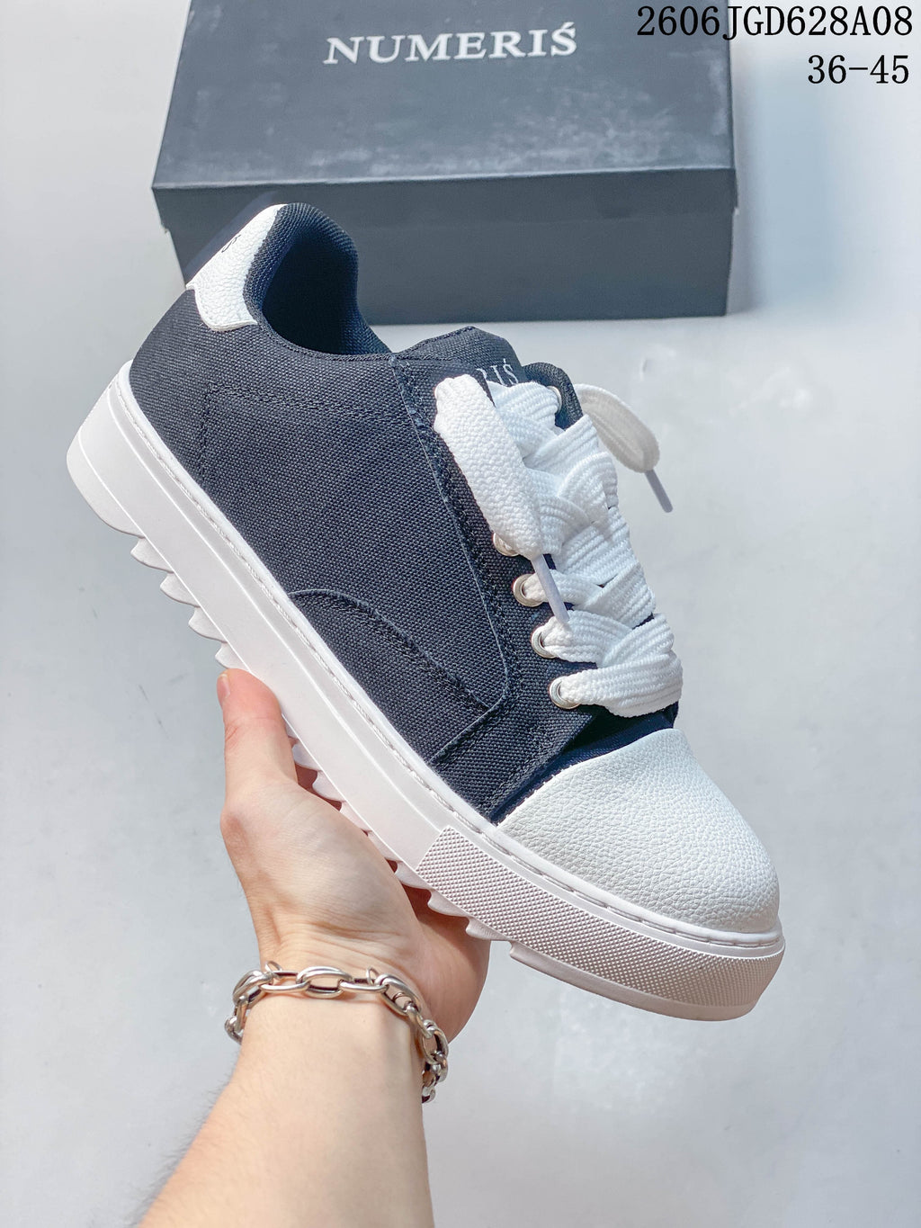 Navy low-top sneaker with a white toe and sole and plain side panels.