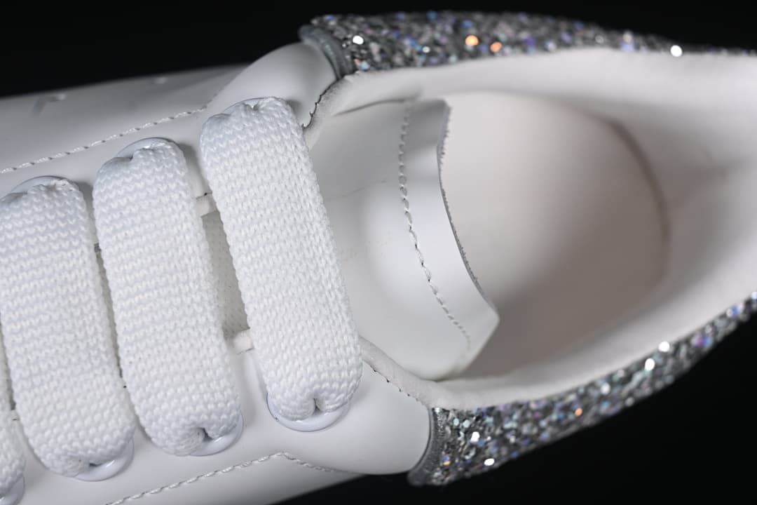 Close-up of the white laces, tongue, and shoe opening.