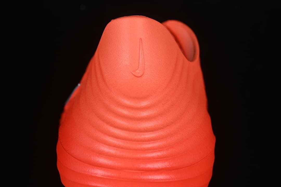 Rear view showing the ridged heel of the orange clog sandal