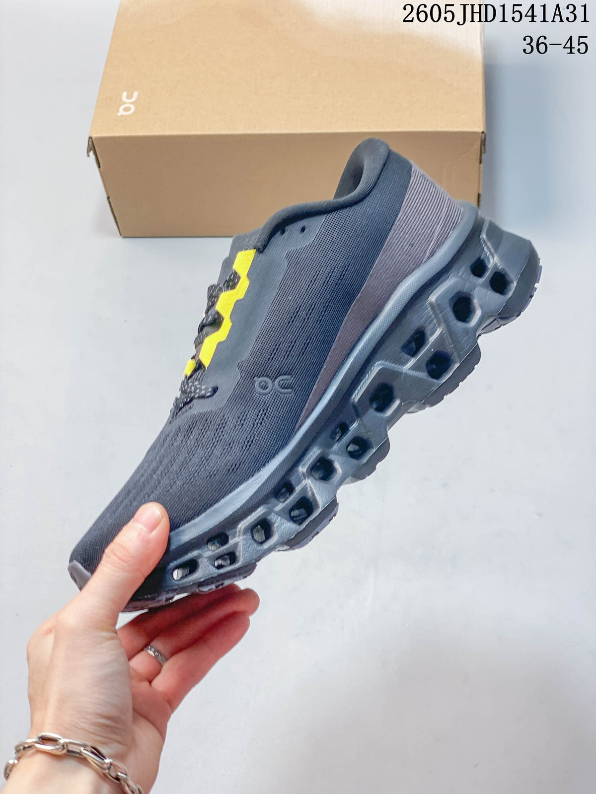 Side view of a charcoal low-top running shoe with yellow lace accents and a sculpted outsole.
