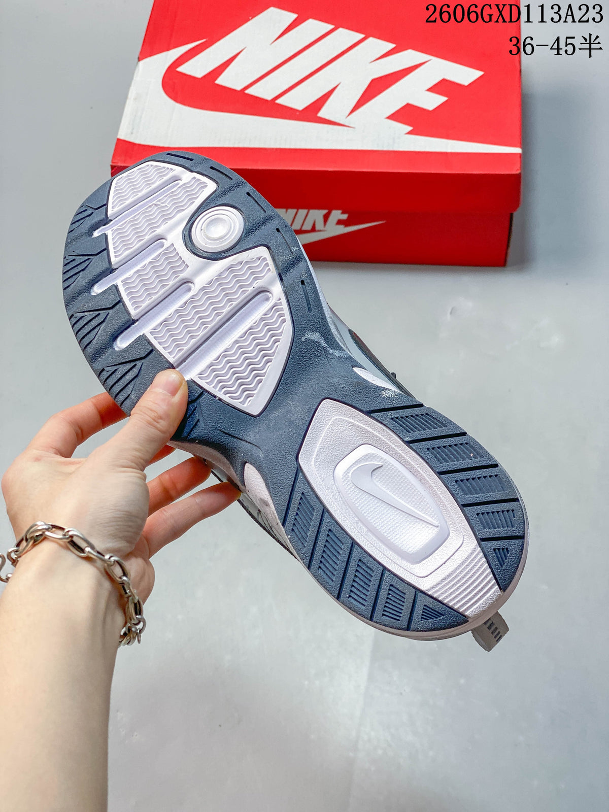 Close-up of the sneaker outsole, showing white and dark blue tread sections.