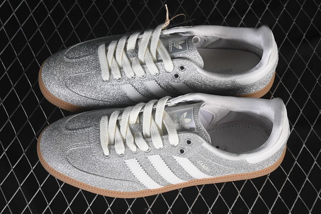 Pair of silver glitter-effect Samba OG sneakers with white stripes and gum-colored soles.