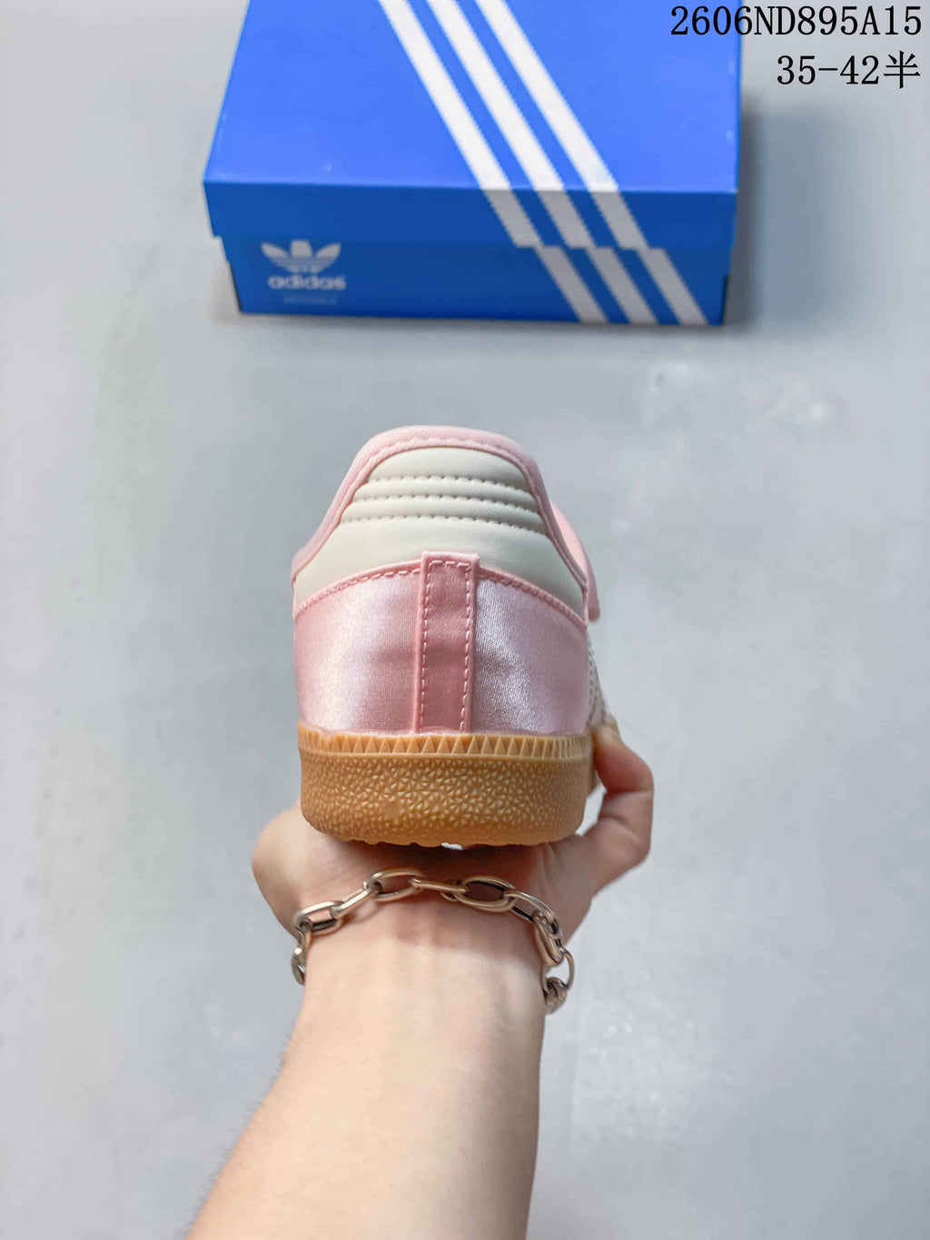 Rear view of the pink sneaker showing the heel and gum-colored sole