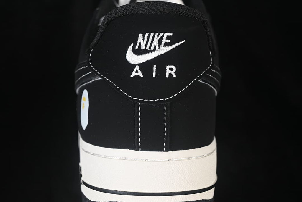 Rear view of the shoe with embroidered Nike Air branding and contrast stitching.