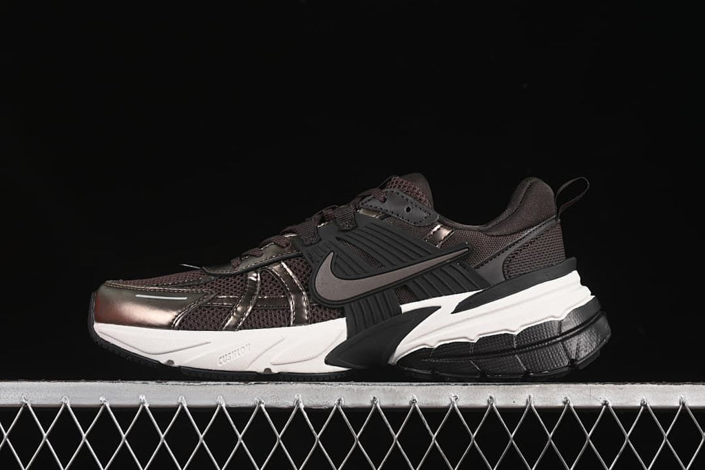 Nike V2K Run sneaker in dark brown with metallic-look overlays and a contrasting sole