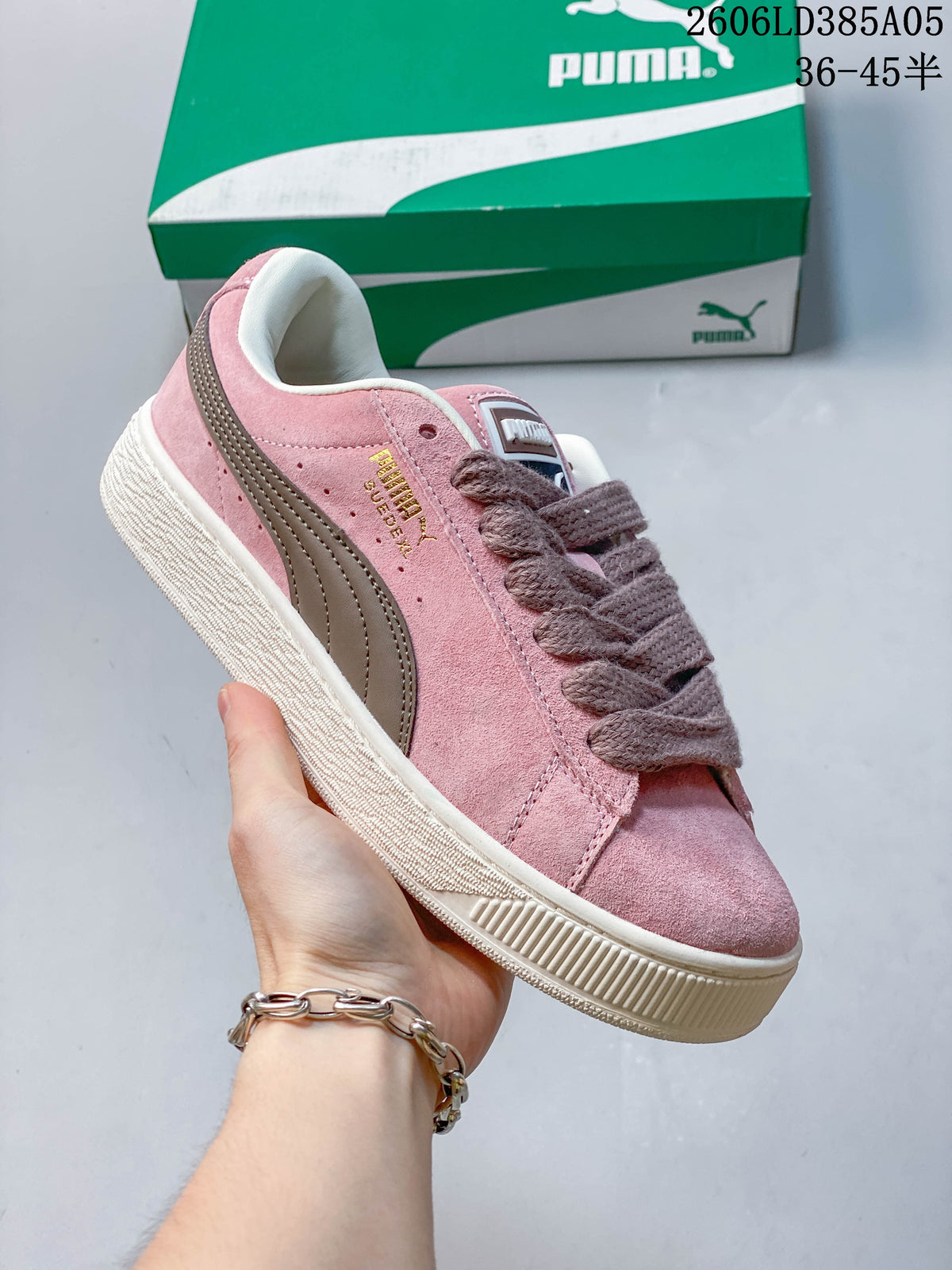 Angled side view of a pink PUMA sneaker with a contrasting stripe and textured sole