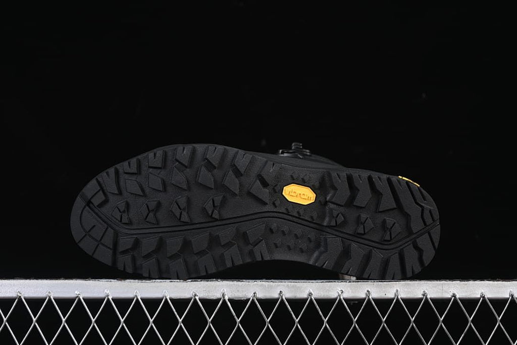 Underside of the boot showing a patterned lug outsole and Vibram mark.