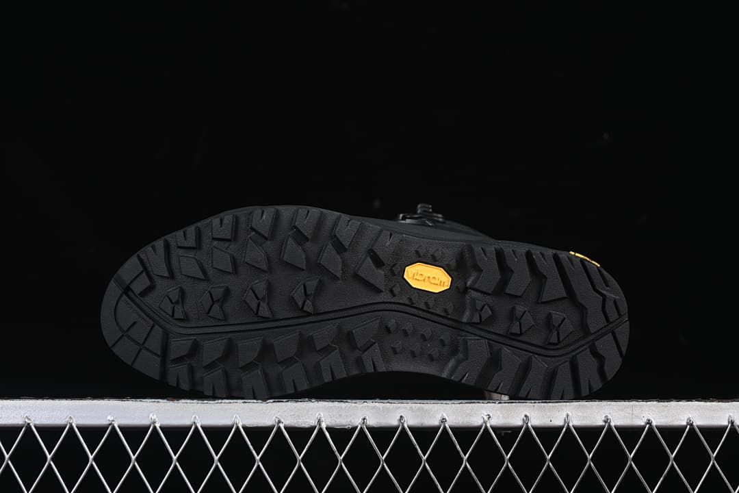 Underside of the boot showing a patterned lug outsole and Vibram mark.