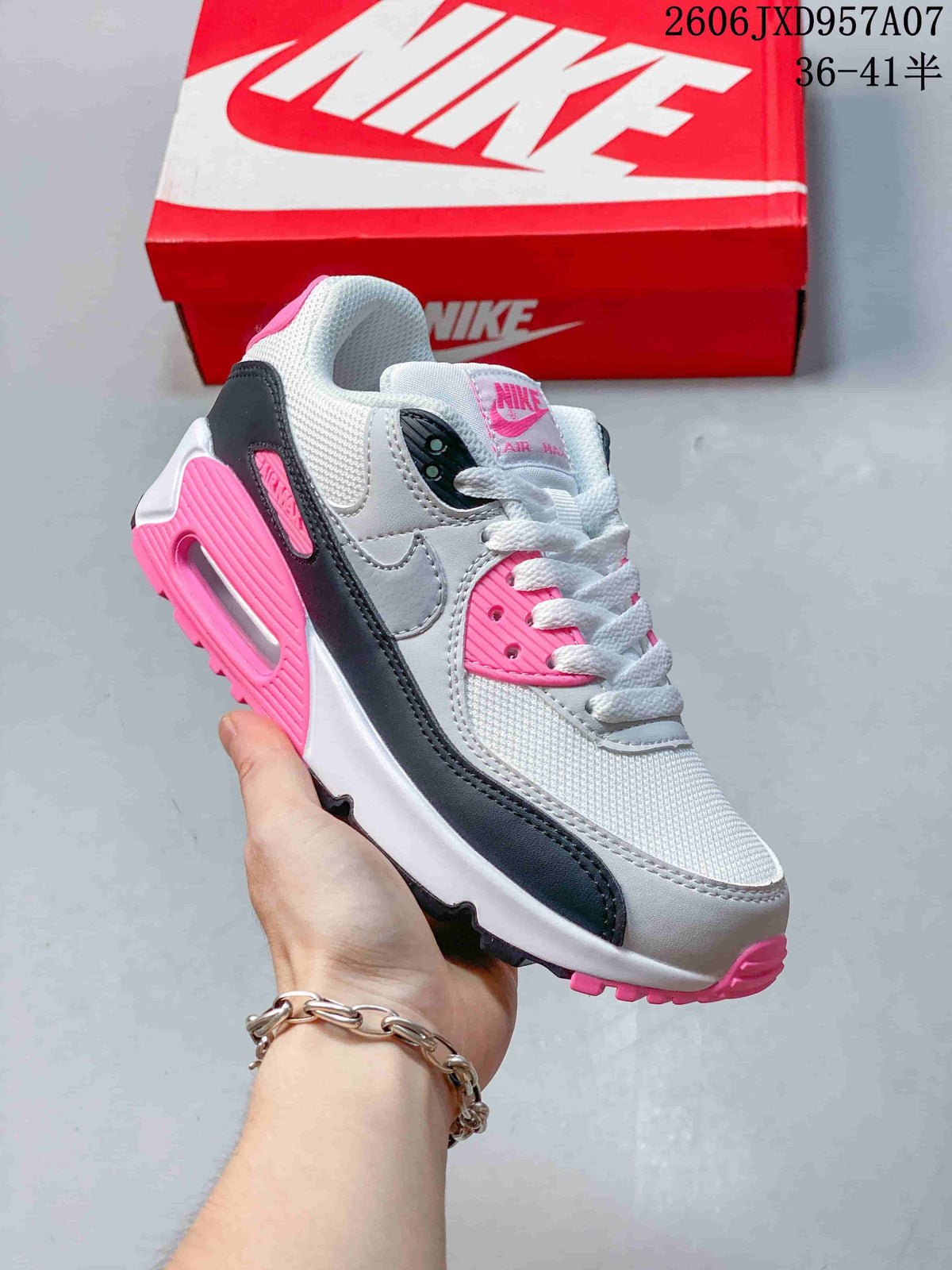 Angled side view of a Nike Air Max 90 sneaker in white, gray, black, and bright pink