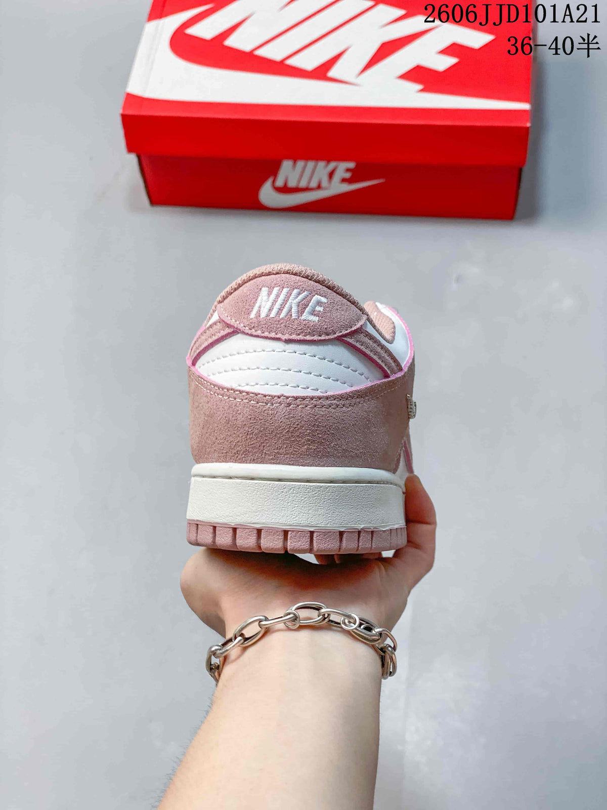 Rear view of the pink and white low-top sneaker.