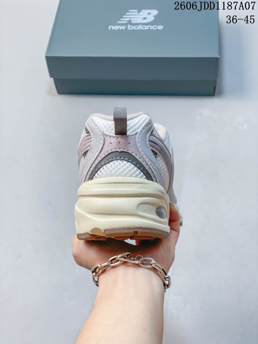 Rear view showing the heel, mesh panels, and cream-colored midsole