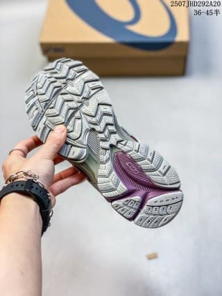 Underside view of the sneaker showing the directional tread pattern and burgundy outsole sections.