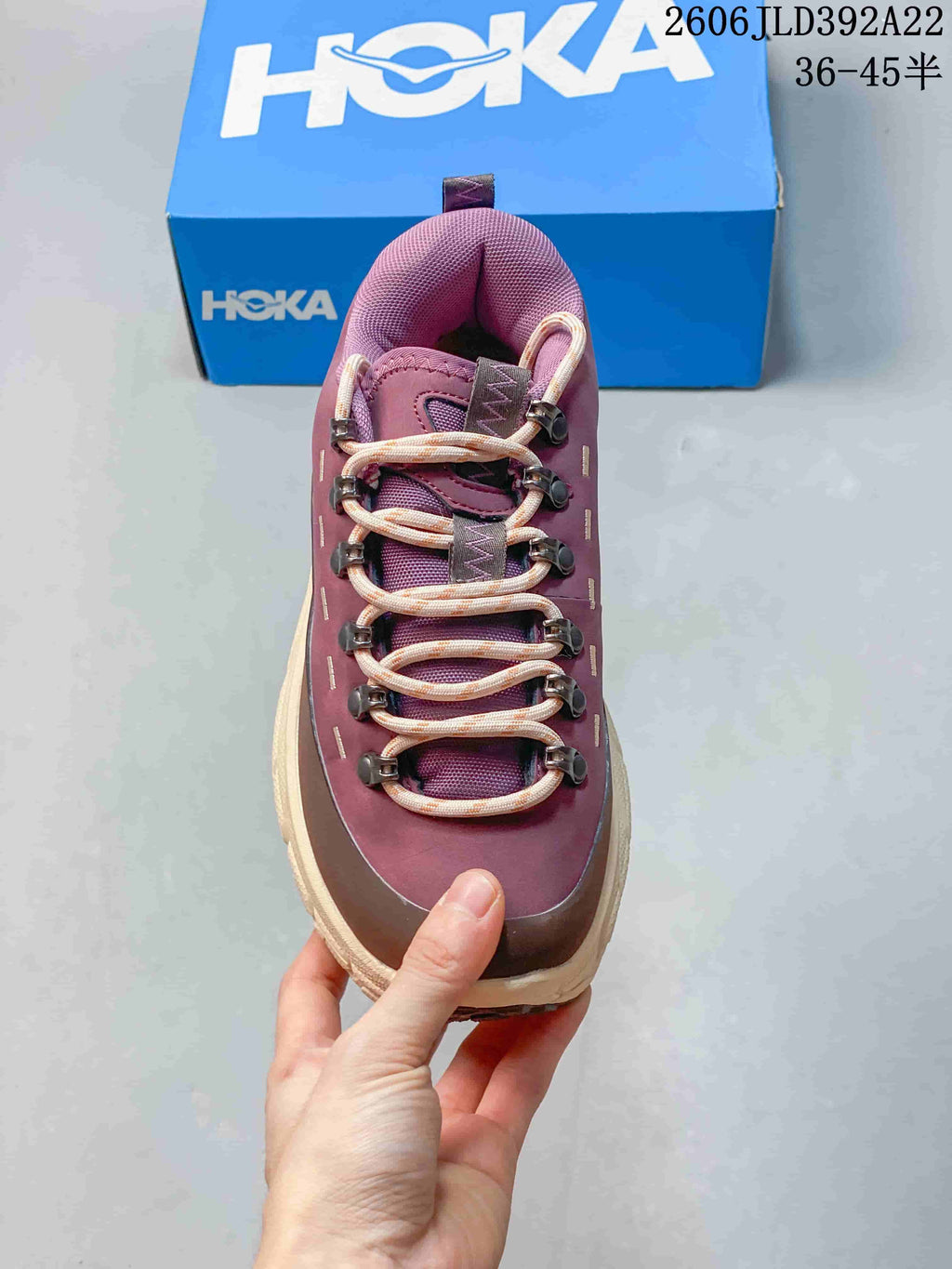 Front view of the plum HOKA Tor Summit sneaker showing its cord-style laces and hook eyelets.