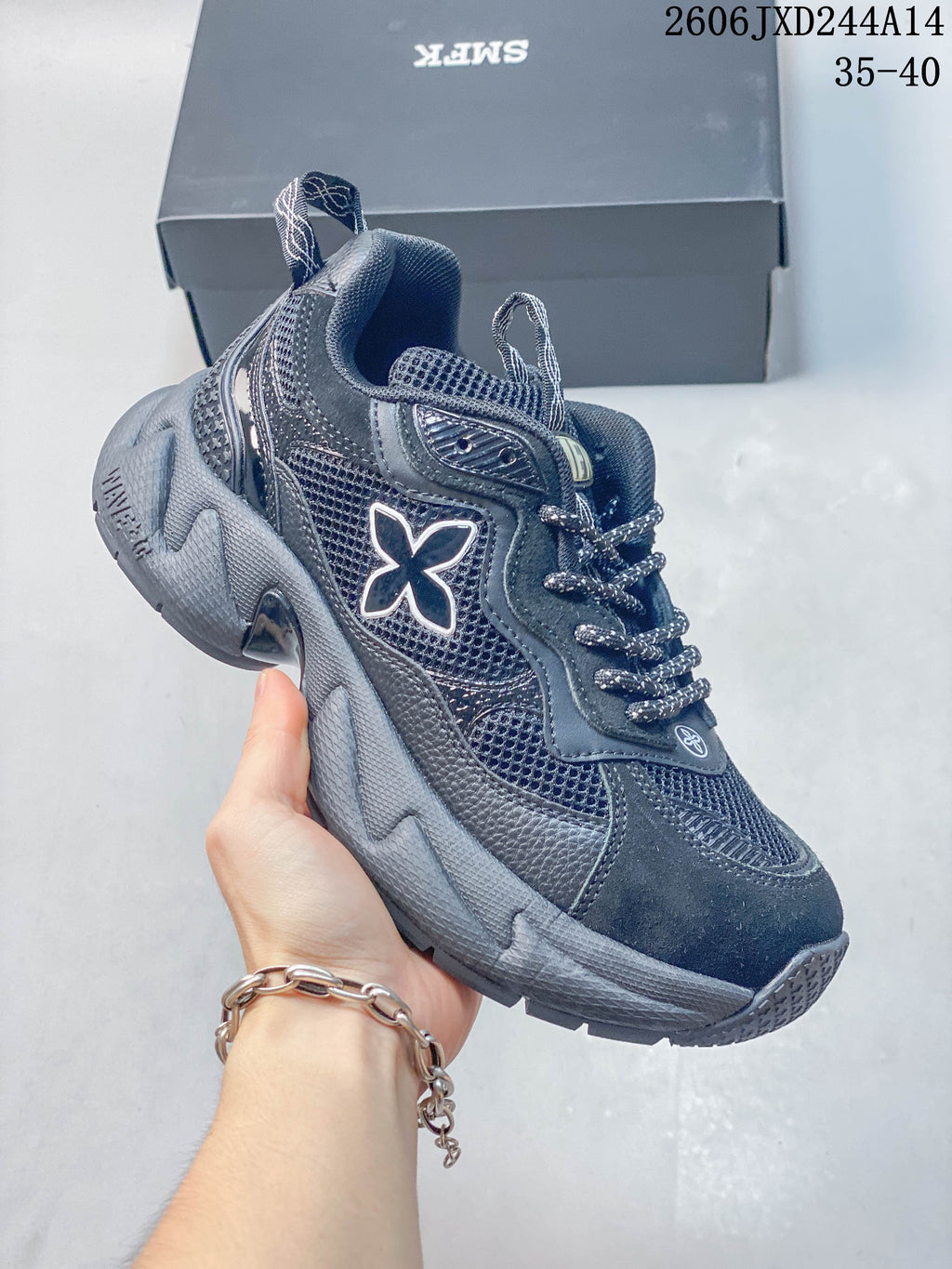 Angled side view of a dark gray sneaker with mesh panels and a sculpted sole