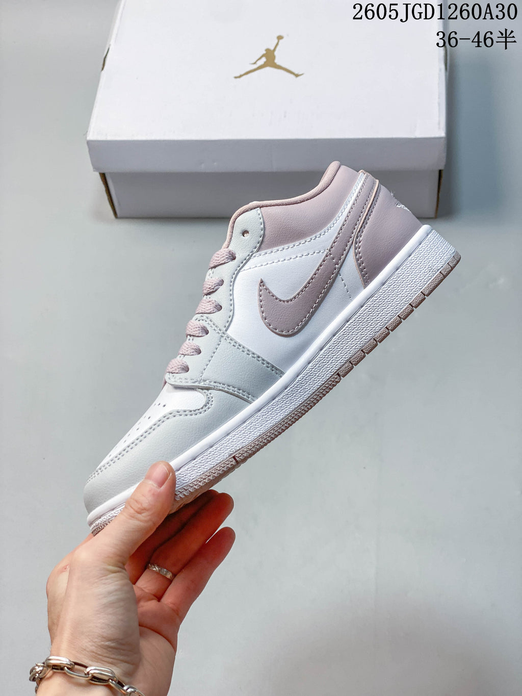 Side profile of a white and blush-pink low-top sneaker