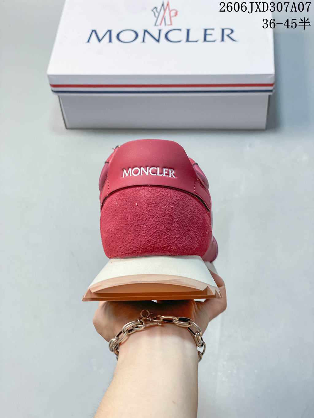 Rear view showing a rose-pink sneaker heel and layered cream and tan sole.