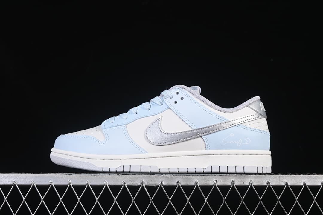Side profile of a light blue, white, and silver low-top Nike Dunk sneaker