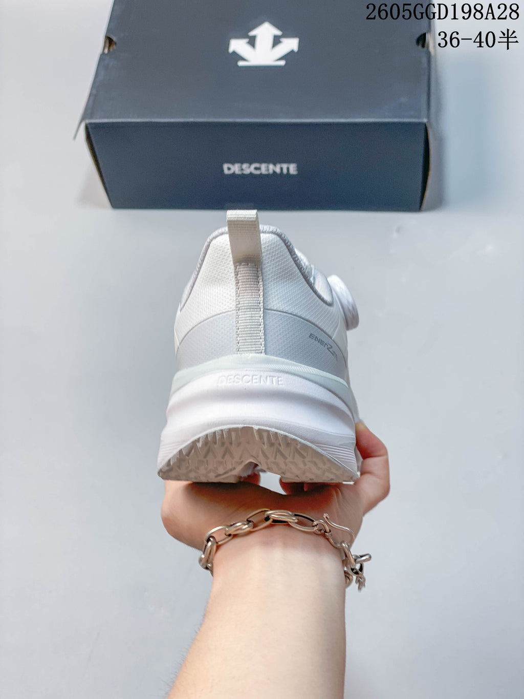 Rear view of the white sneaker showing the heel and sole