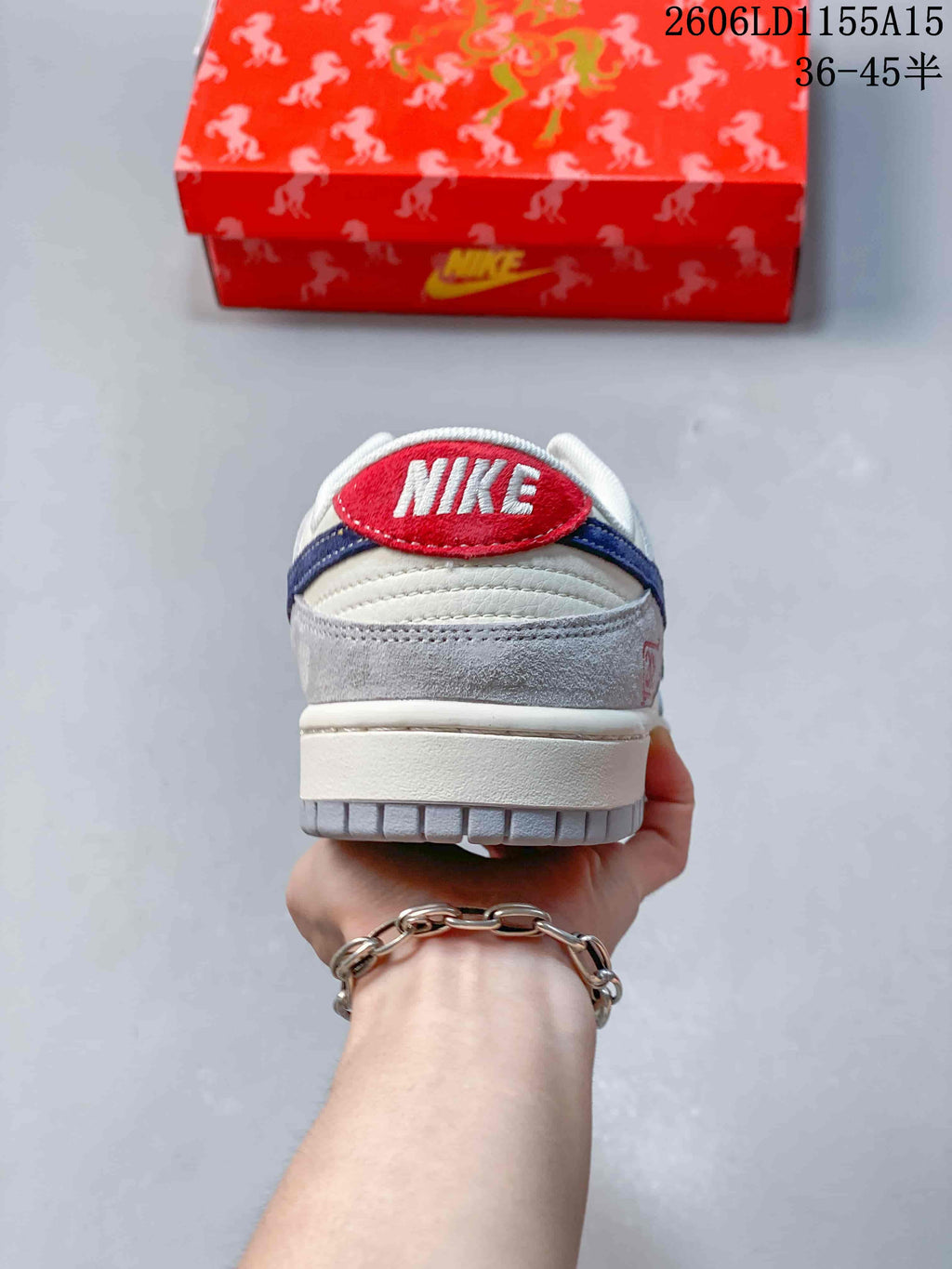 Rear view of the sneaker showing a red Nike heel patch and navy accent
