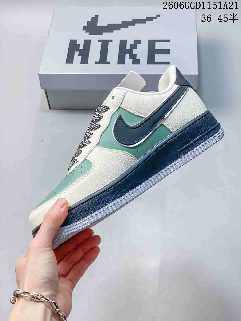 Side view highlighting the mint-green panels, off-white sections, and dark Swoosh