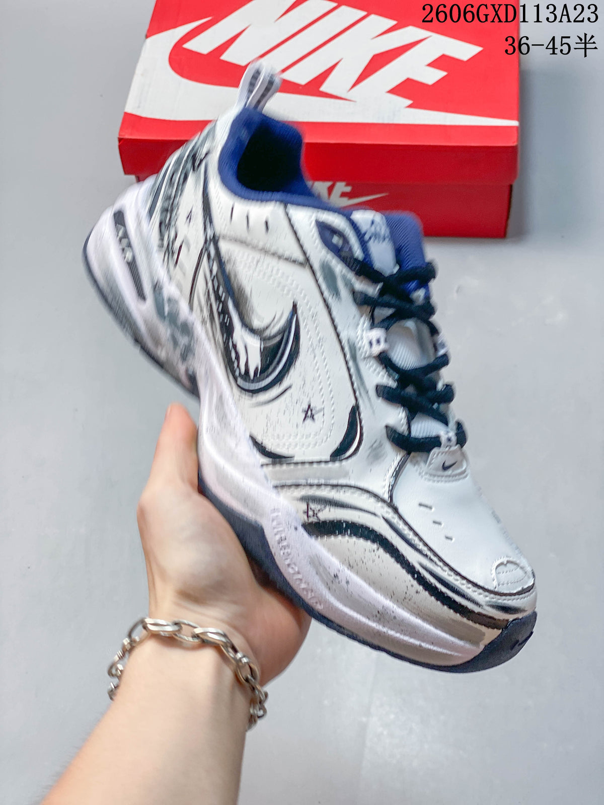 Close side view of a Nike Air Monarch sneaker showing its layered design and contrast detailing