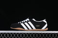 Side view of the black adidas Tokyo sneaker with white stripes and gum-colored sole