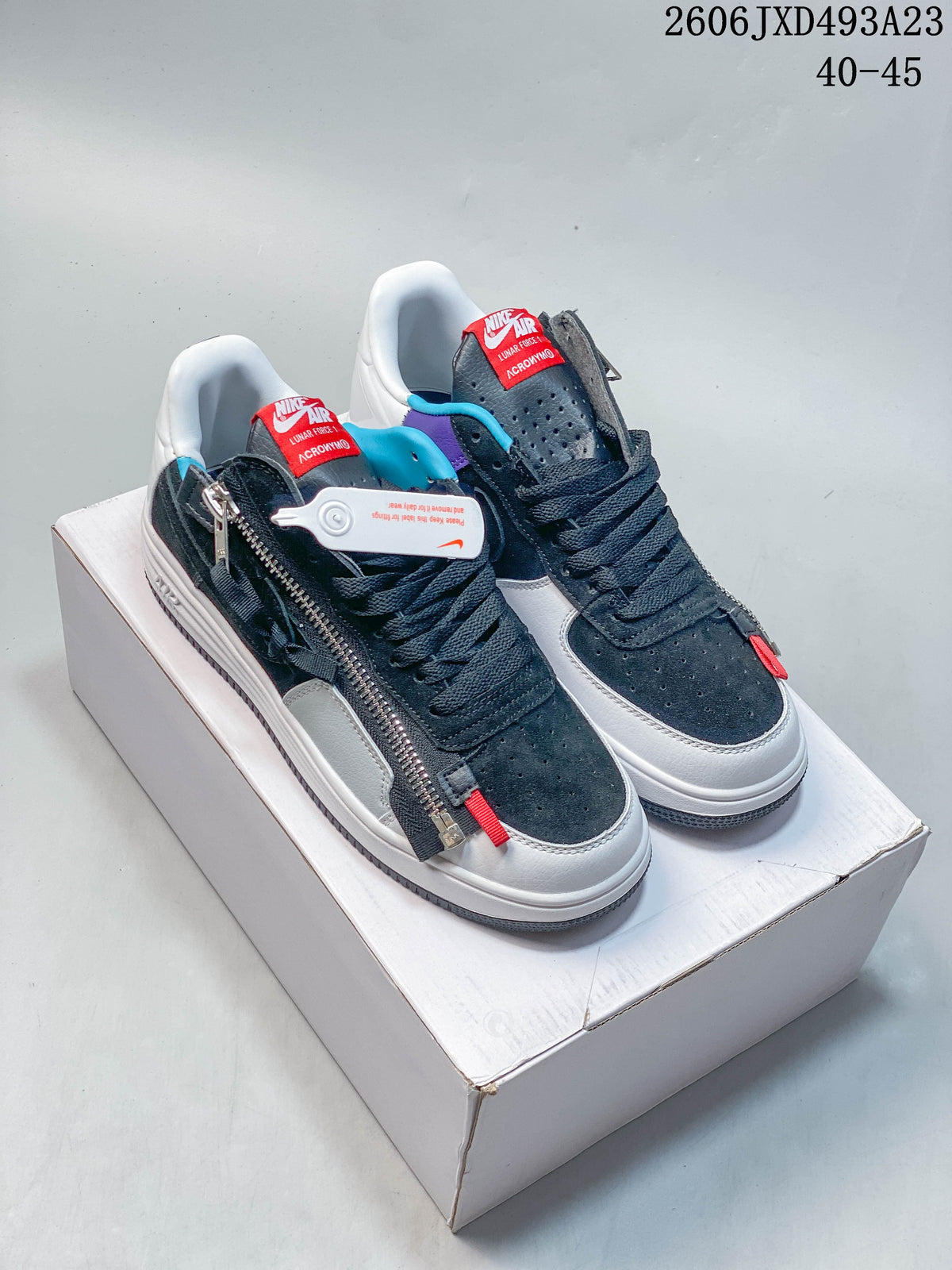 Pair of white and navy low-top Nike sneakers with colorful accents, shown from above
