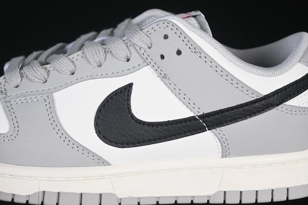 Close-up of the black side Swoosh, grey overlays, and laces