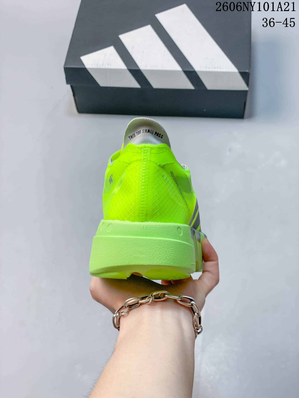 Rear view showing the neon yellow heel and sculpted sole.