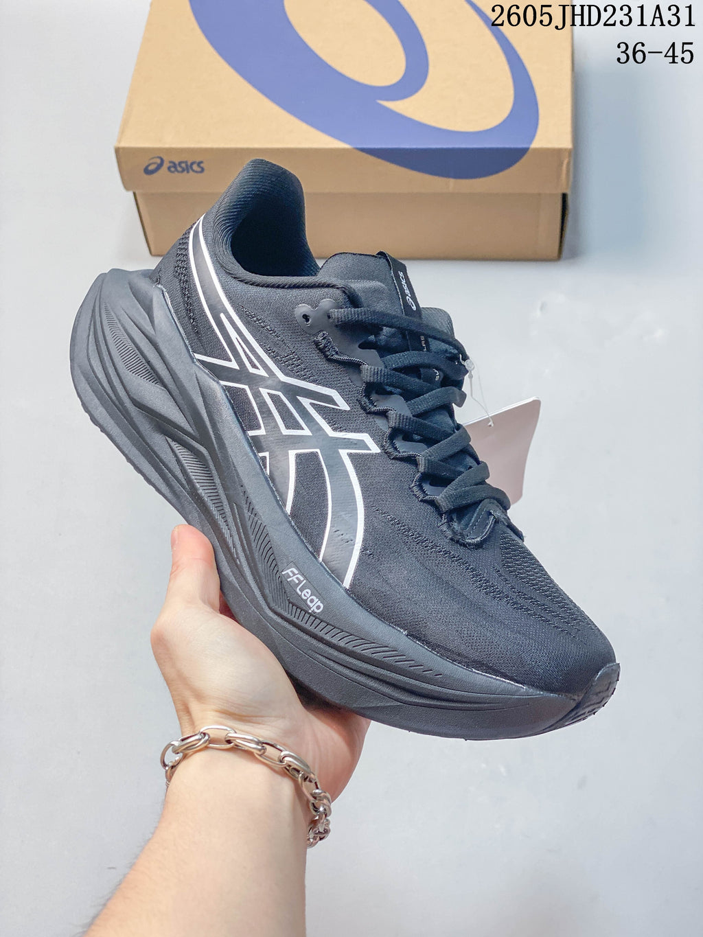 Side profile of a dark gray ASICS MEGABLAST running shoe