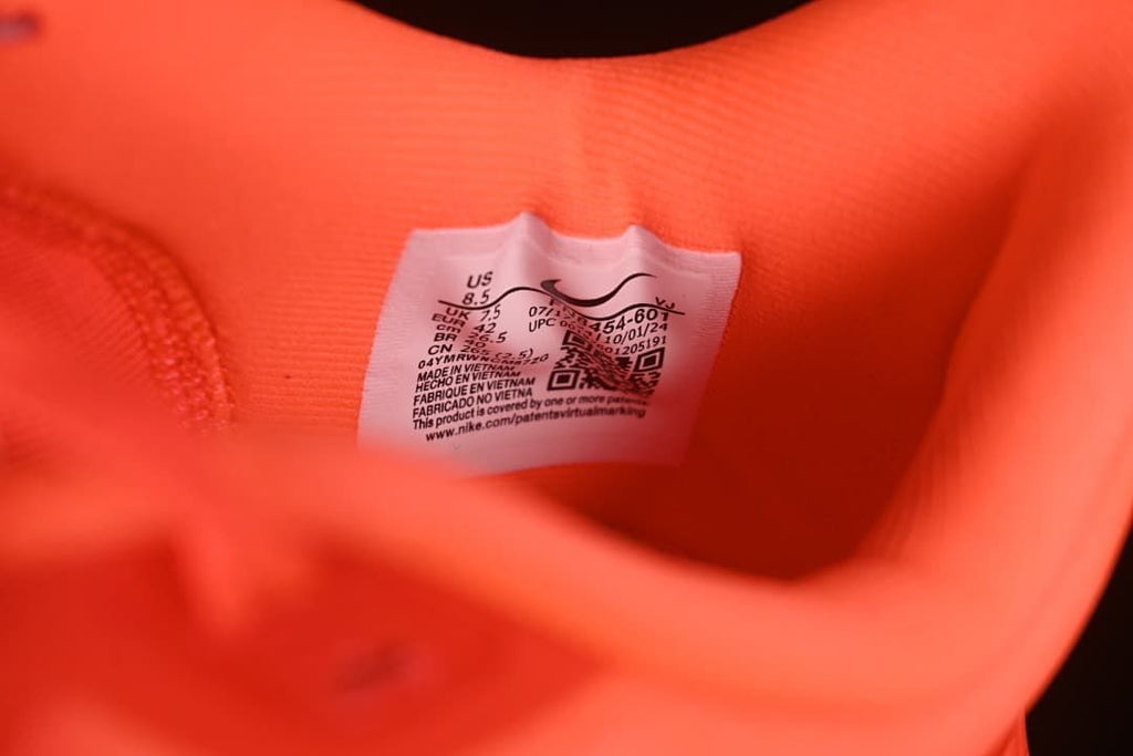 Interior size label inside the coral shoe; photographed sample marked US 8.5 and EU 42