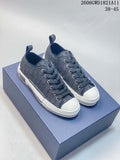 Pair of gray patterned Dior B23 low-top sneakers with white toe caps and soles