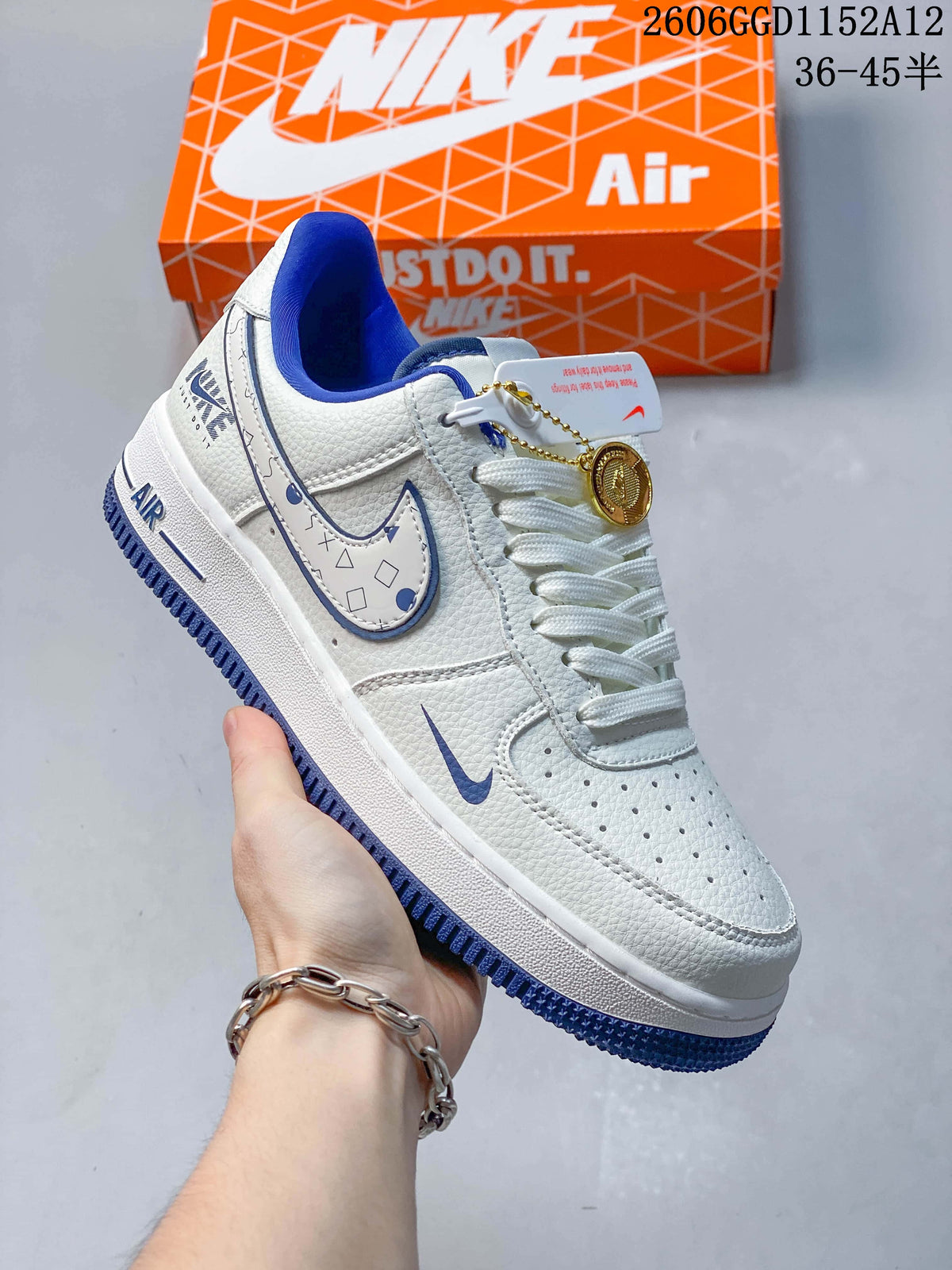 Angled side view showing the patterned Swoosh and gold-tone charm