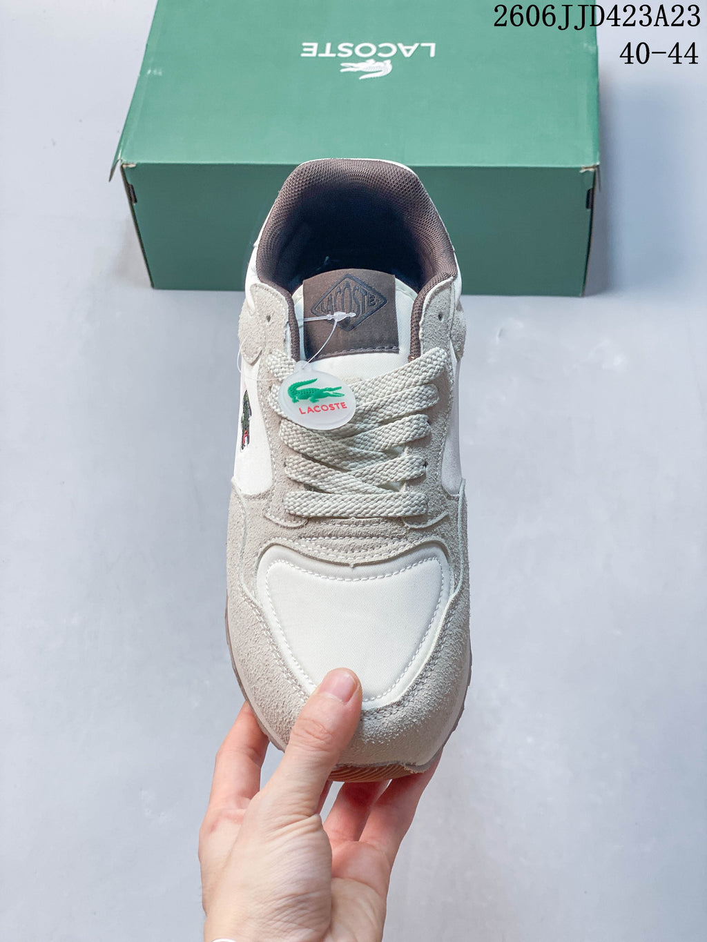 Front view of the sneaker showing its laces, layered toe panels and tongue label.