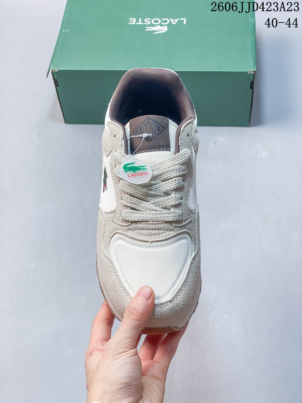 Front view of the sneaker showing its laces, layered toe panels and tongue label.