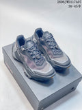 Pair of gray Kailas FUGA trail running shoes shown from the front on a shoe box