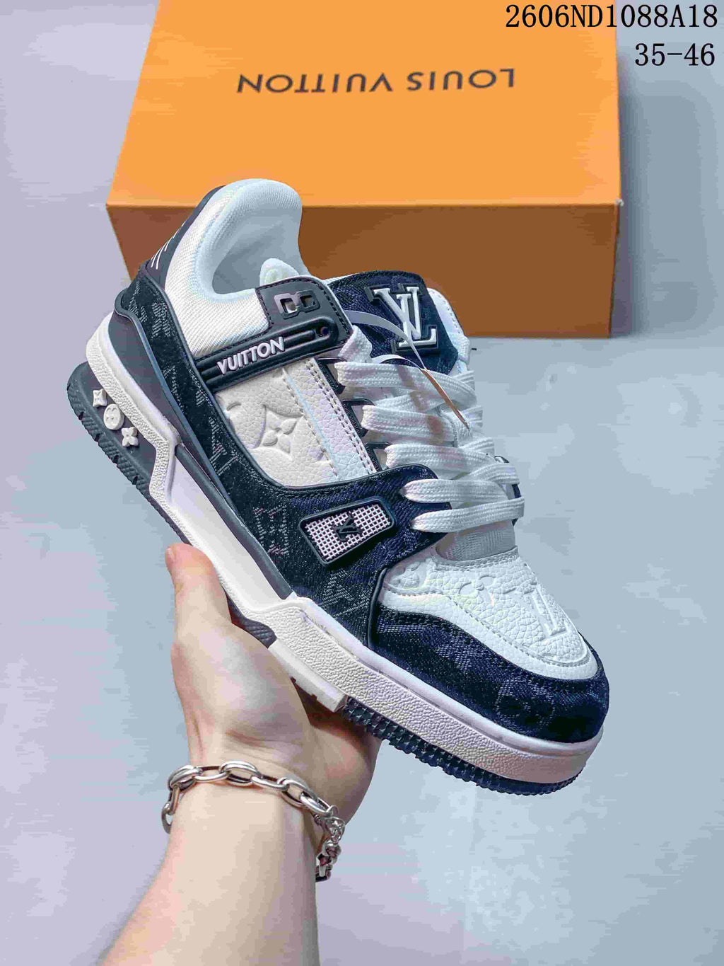 Angled side view of the white and navy low-top sneaker
