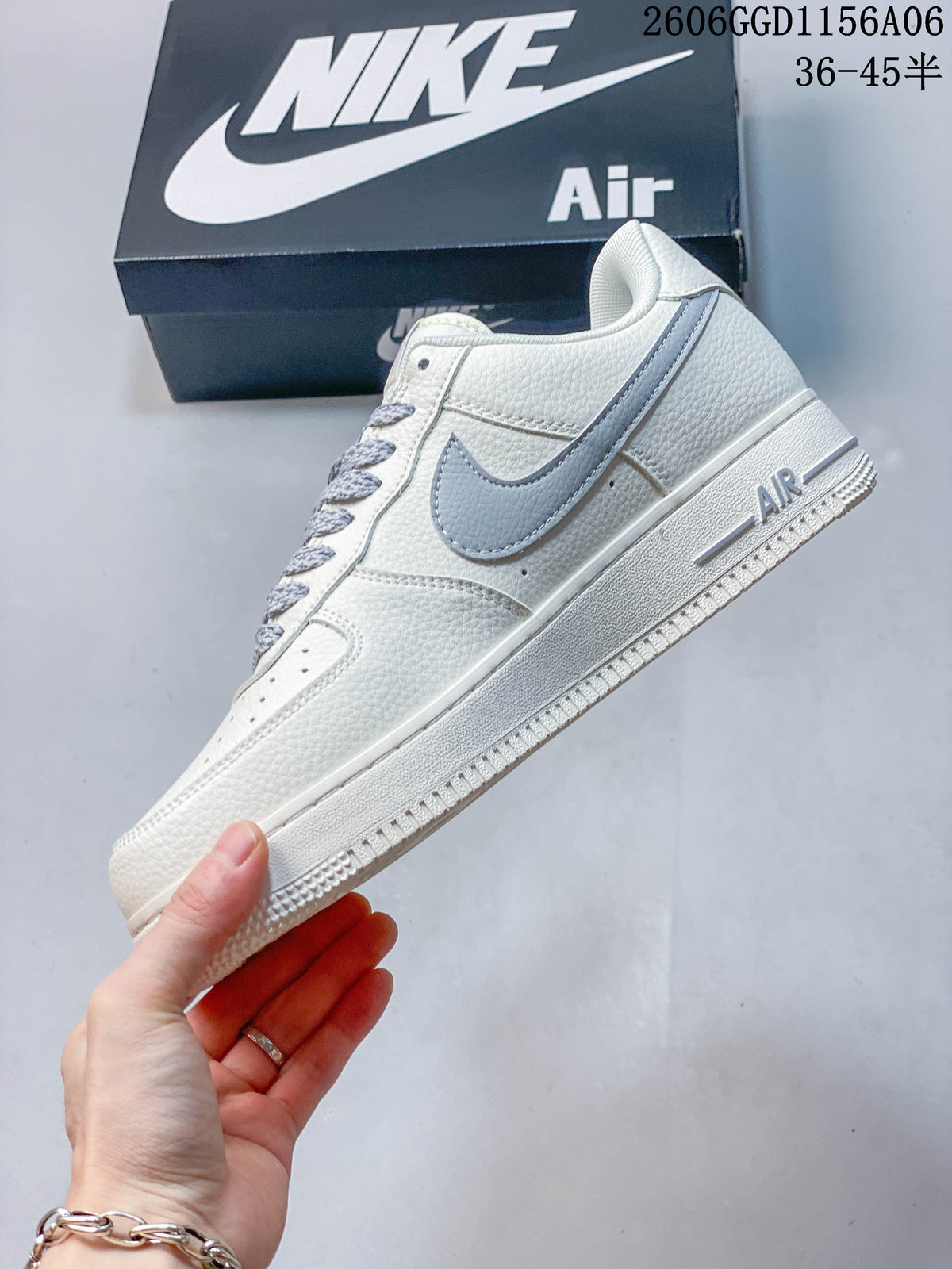 Side view of an ivory Nike Air Force 1 with grey Swoosh detailing