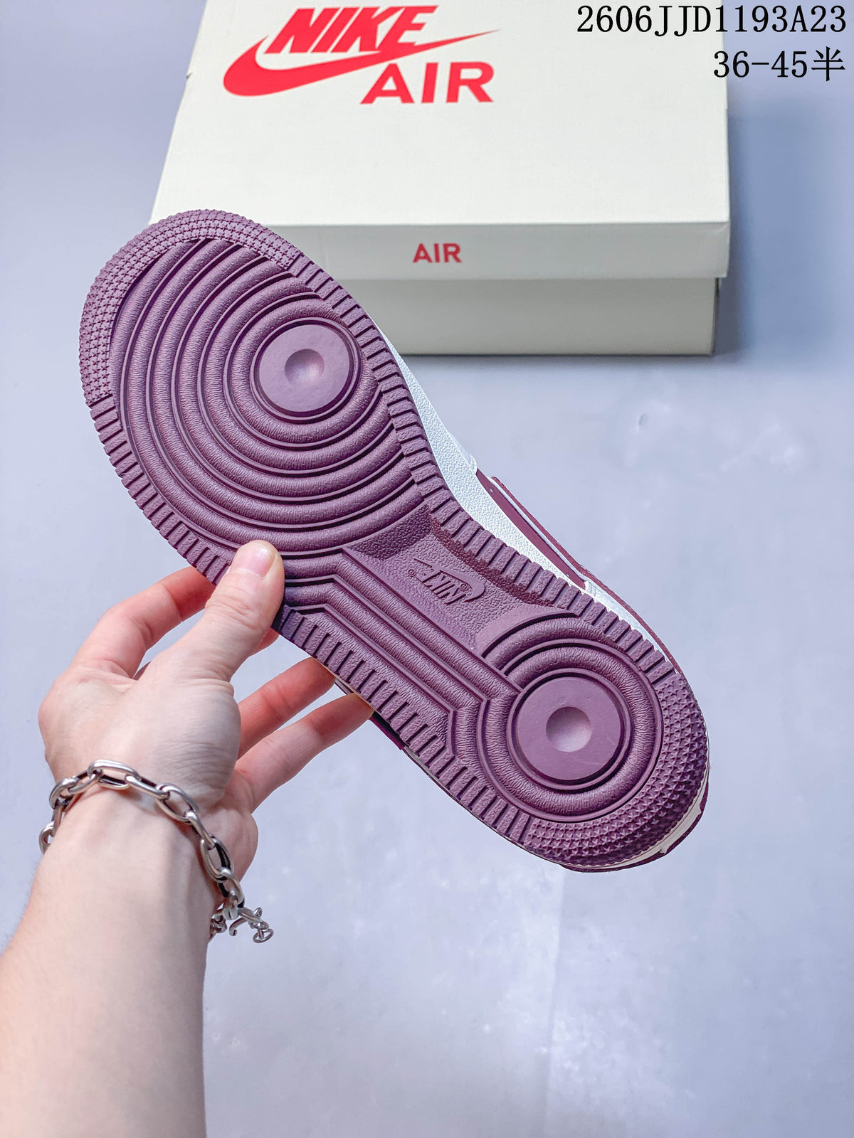 Burgundy outsole with circular tread details.