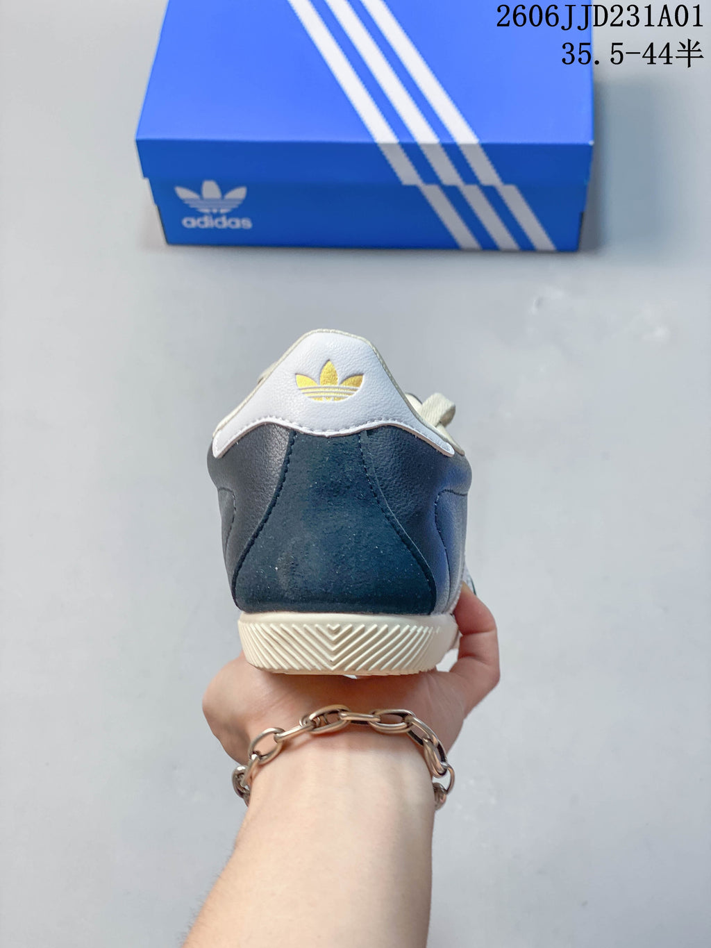 Rear view of the navy sneaker showing a white heel tab and cream outsole