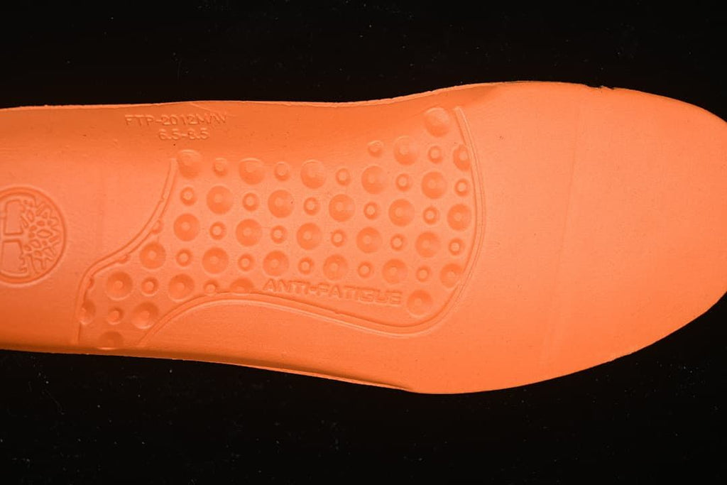 Orange outsole detail with molded markings, including “ANTI-FATIGUE.”