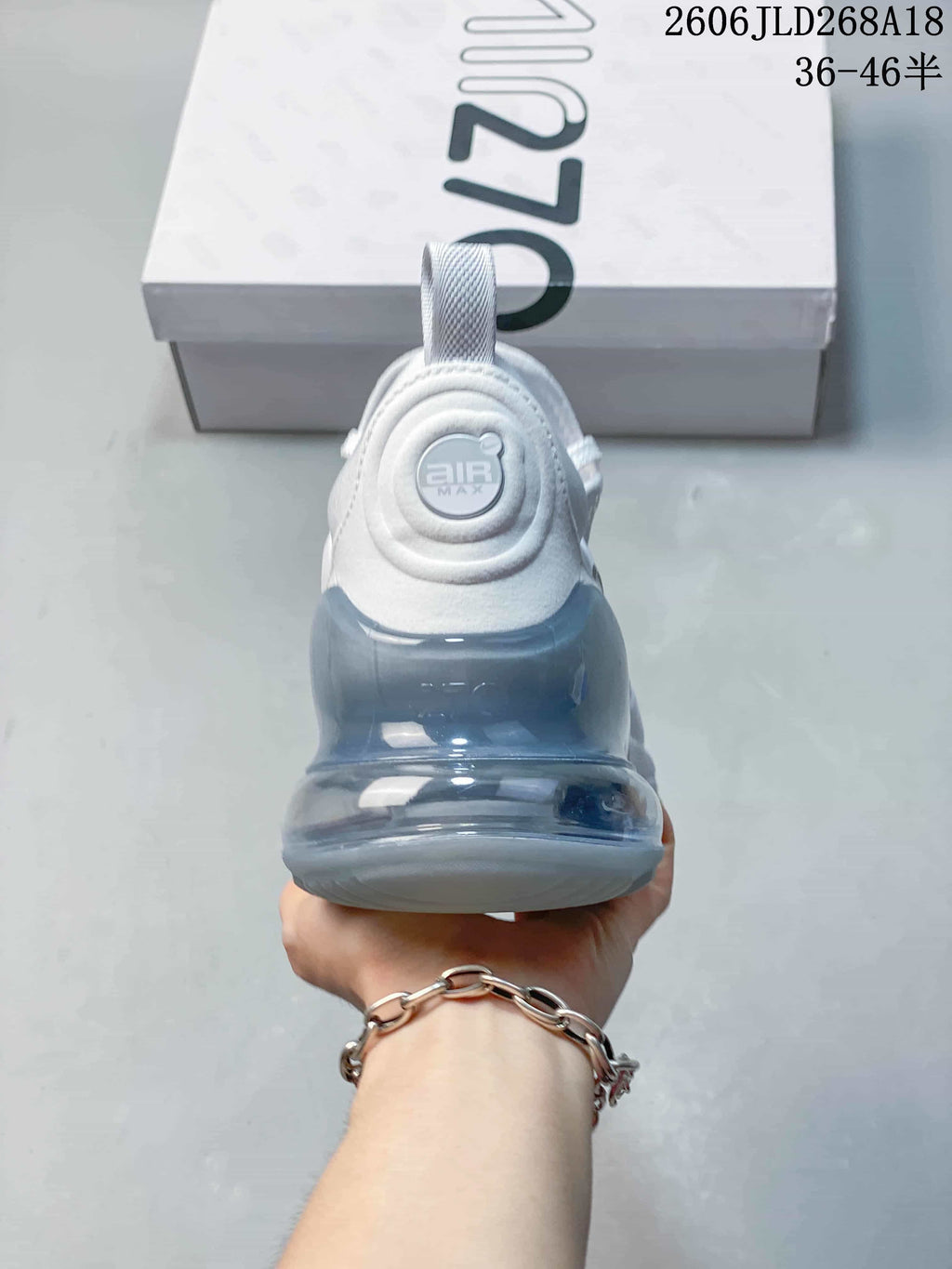 Rear view of a white Nike Air Max Pulse shoe with a translucent heel unit