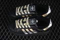 Pair of black adidas Superstar II sneakers with metallic gold and silver stripes and patterned white laces.