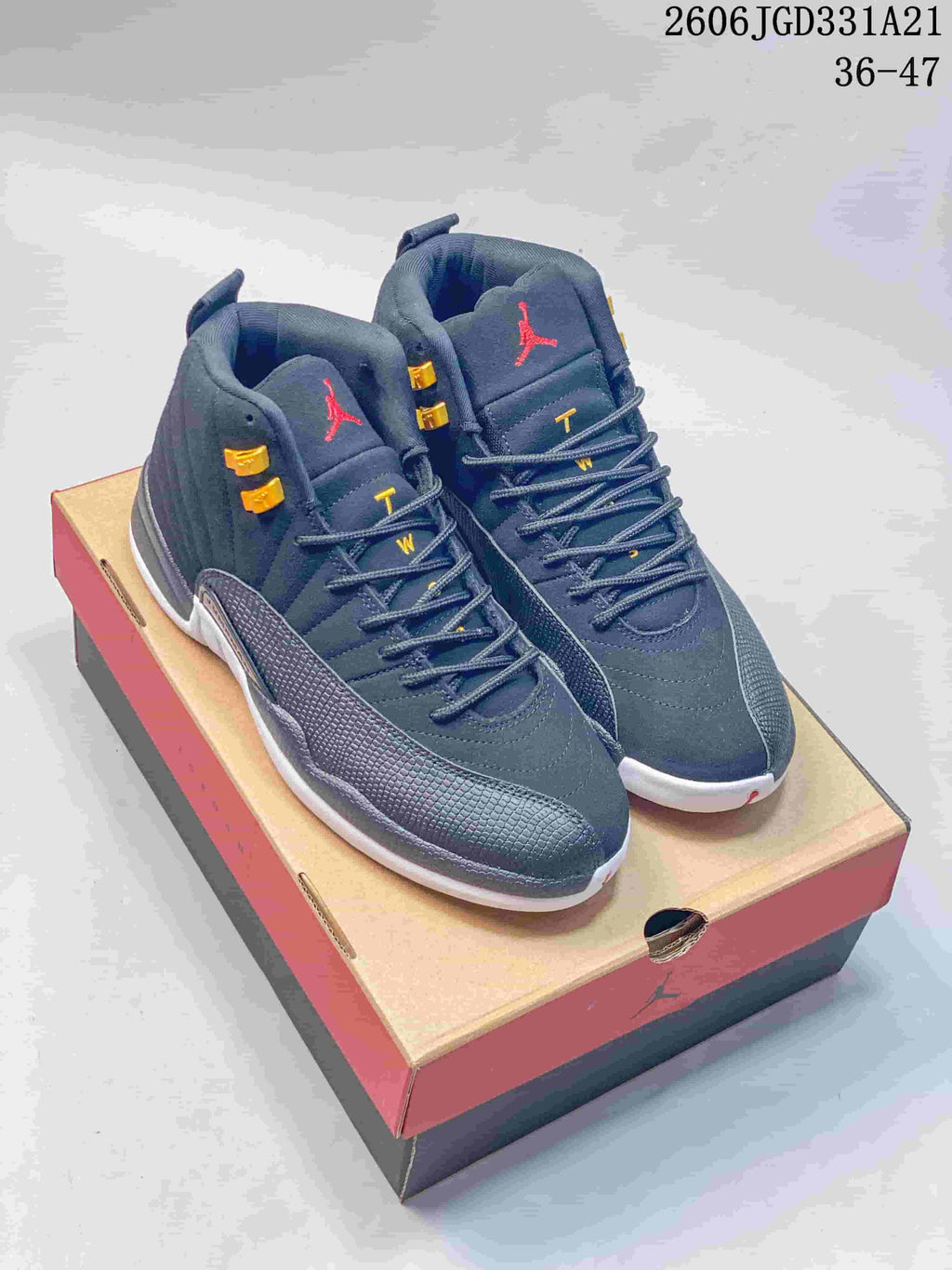 Dark gray high-top Air Jordan 12 shoes with gold-tone lace hardware